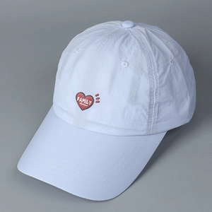 Close-up of white breathable baseball cap with red heart and FAMILY embroidery detail