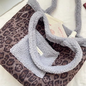 Detail of leopard print tote bag featuring fuzzy faux fur trim and interior side pocket