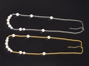 Detail view of gold and silver tone pearl necklaces with lobster clasp and extension chain