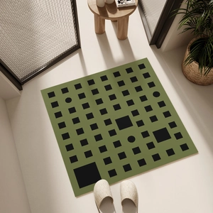 Absorbent green bathroom floor mat with black geometric patterns in a modern home setting