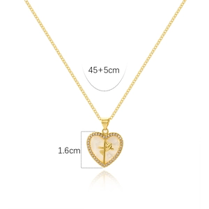 Close-up of golden heart pendant with mother of pearl inlay and crystal border, 1.6cm size