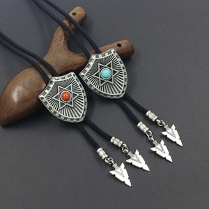 Close-up of vintage silver shield Bolo ties with turquoise and carnelian stones