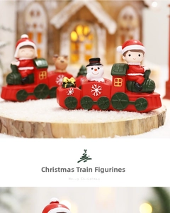 Detailed view of red and green Christmas train ornaments with Santa and snowman figures