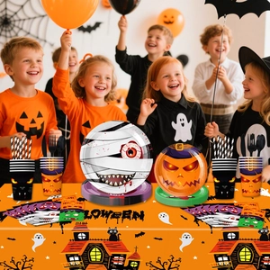 Halloween party tableware set featuring mummy and pumpkin paper plates with festive backdrop