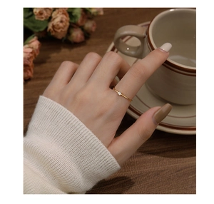 Close-up of minimalist gold S925 silver ring with square zircon on a hand