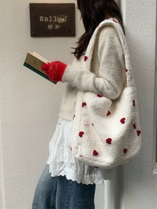 Plush white shoulder tote bag with red heart patterns for women in winter fashion style