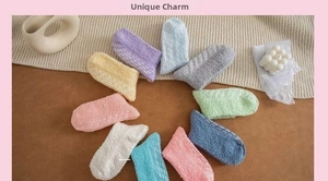 Detail view of colorful coral fleece socks with non-slip silicone grippers on the sole