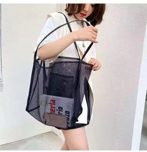 Detail view of black mesh tote bag showing interior pocket and semi-transparent design