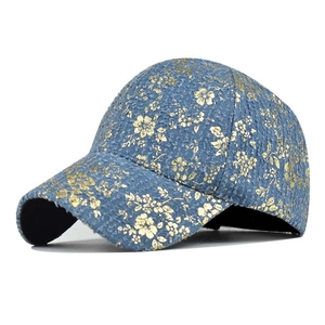 Dark blue baseball cap featuring intricate gold floral patterns and textured fabric