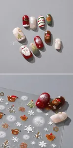 Macro shot of 3D embossed Christmas nail stickers featuring Santa, reindeer, and snowflakes