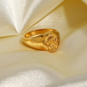 Exquisite 18k gold plated stainless steel angel signet ring on beige silk background
