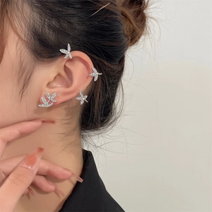 Detail view of silver butterfly ear cuff wrap with sparkling cubic zirconia on model
