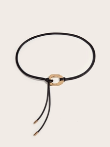 Detailed view of black knotted leather rope belt with elegant gold irregular oval buckle