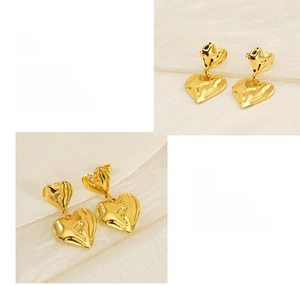 Detail of double heart earrings featuring gold liquid metal texture and polished finish