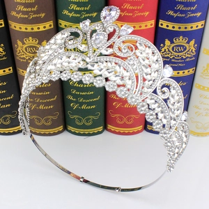 Detailed view of silver zircon bridal crown with leaf motifs on vintage book background