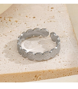 Macro detail of silver adjustable ring featuring irregular hammered texture and wavy edges
