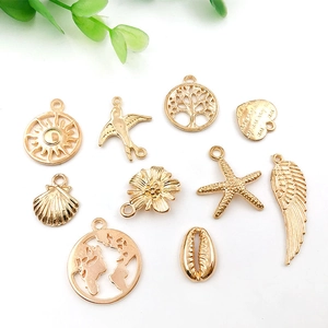Assorted gold alloy charms including sun tree heart and bird shapes for DIY jewelry making