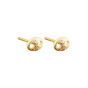 Elegant gold pig nose stud earrings with white zircon crystals on a plain white background