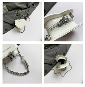 Detail view of white heart-shaped mini crossbody bag with silver metal chain and beads