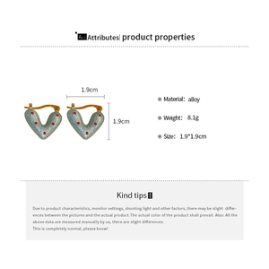 Detail view of heart-shaped blue and red polka dot earrings with dimension markings
