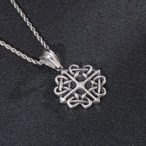 Macro detail of silver celtic knot circular pendant with intricate polished metal texture
