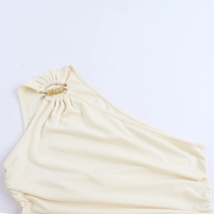 Detail of cream knit dress neckline with elegant ruching and a decorative metal ring