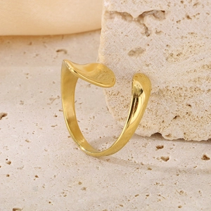 Irregular 18K gold plated stainless steel open ring on a beige stone block