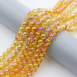 Macro shot of 8mm yellow amber AB rainbow plated glass beads on a display roll