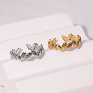 Detailed view of adjustable leaf-shaped stainless steel rings in gold and silver finish