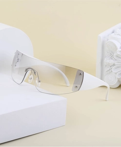 Macro shot of Y2K rimless sunglasses with white temples and silver stud details