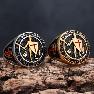 Detail of vintage shield rings with knight relief and engraved Bible verse on bark