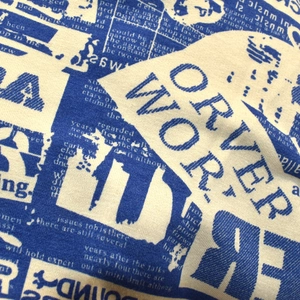 Detailed macro view of retro letter print on cream-colored knitted cotton street style beanie