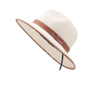 Straw fedora hat in beige with brown leather trim and metallic studs for sun protection