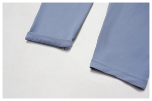 Detailed close-up of blue yoga pants hem showing high-quality double-stitch flat seams