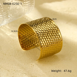 Close-up of golden braided texture on 4cm wide stainless steel open cuff bracelet