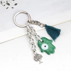 Pink evil eye keychain with Hamsa hand, blue tassel and silver tree of life charm