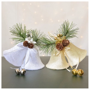 Detail of velvet Christmas bells with pine cones and festive pine needle decor