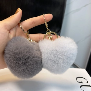 Plush heart-shaped rabbit fur keychains in dark grey and light blue with gold rings
