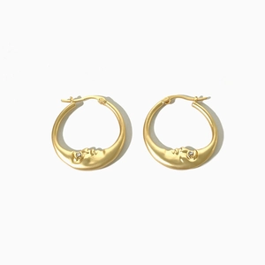 Minimalist matte gold moon earrings with crystal rhinestones on a white background