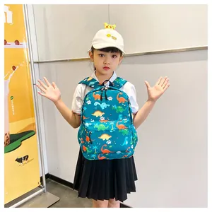 Detail of teal toddler backpack with colorful cartoon dinosaur prints and black zippers