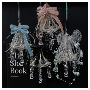 Detailed view of crystal glass hanging ornaments with velvet bows and soft feathers