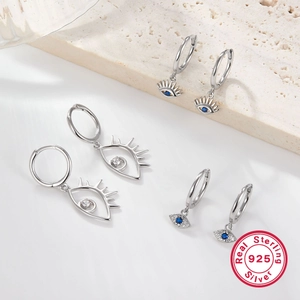 925 sterling silver evil eye hoop earrings with blue zircon on marble background