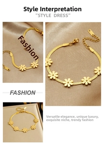 Detailed view of gold plated daisy pendants on a flat snake chain bracelet with extension