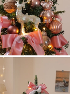 Close-up of pink bows, rose gold balls, and pearl deer ornaments on a mini Christmas tree