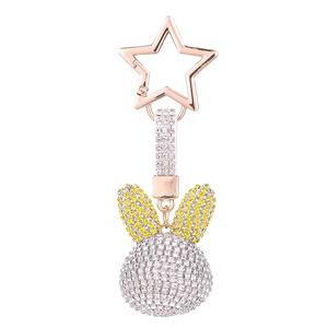 Sparkling rhinestone rabbit head keychain with rose gold star clasp on white background