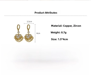 Detailed specs of gold heart earrings with copper and zircon tassels, 1.5cm by 4cm