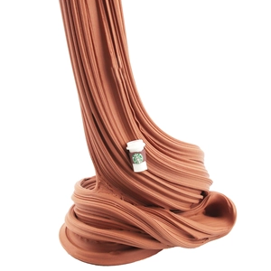 Detailed texture of brown butter slime featuring a miniature coffee cup charm detail