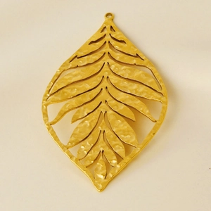 Detailed view of gold stainless steel hollow leaf pendant with hammer texture finish