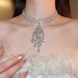 Close-up of multilayer pearl choker with sparkling rhinestone fringe on a model