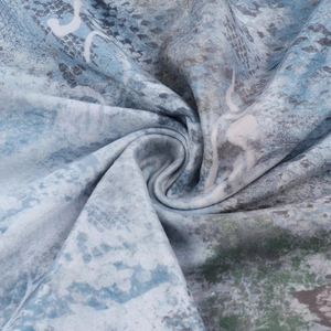 Detailed close-up of abstract blue and grey lace fabric texture with elegant draping